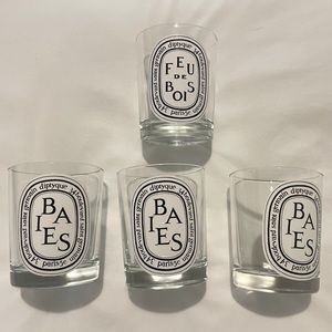 Four empty Diptyque candles
